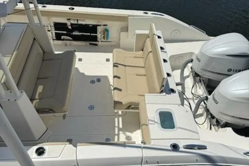  Yacht Photos Pics 2020 Pursuit S 328 Sport boat interior with seating and dual Yamaha engines.