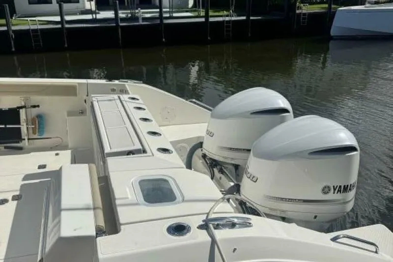  Yacht Photos Pics 2020 Pursuit S 328 Sport boat with twin Yamaha outboard engines docked by the water.