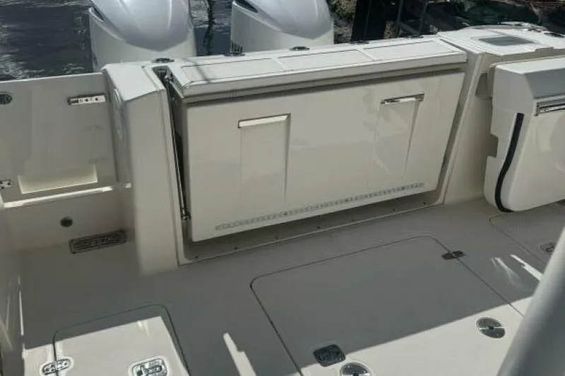  Yacht Photos Pics 2020 Pursuit S 328 Sport boat deck with storage compartments and dual engines.