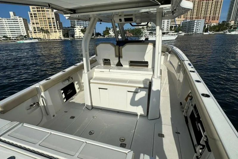  Yacht Photos Pics 2020 Pursuit S 328 Sport boat interior with city skyline in background.