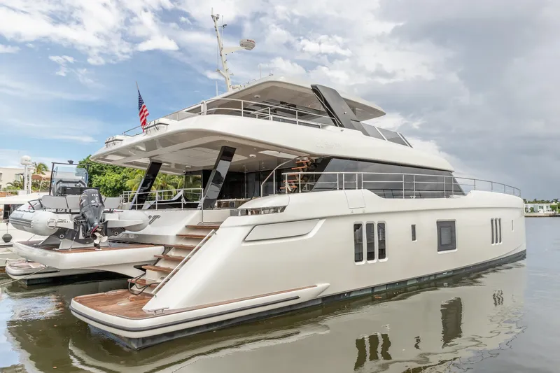 Fat Cat Yacht Photos Pics Luxurious 2024 Sunreef 80 Power yacht docked, showcasing sleek design and modern amenities.