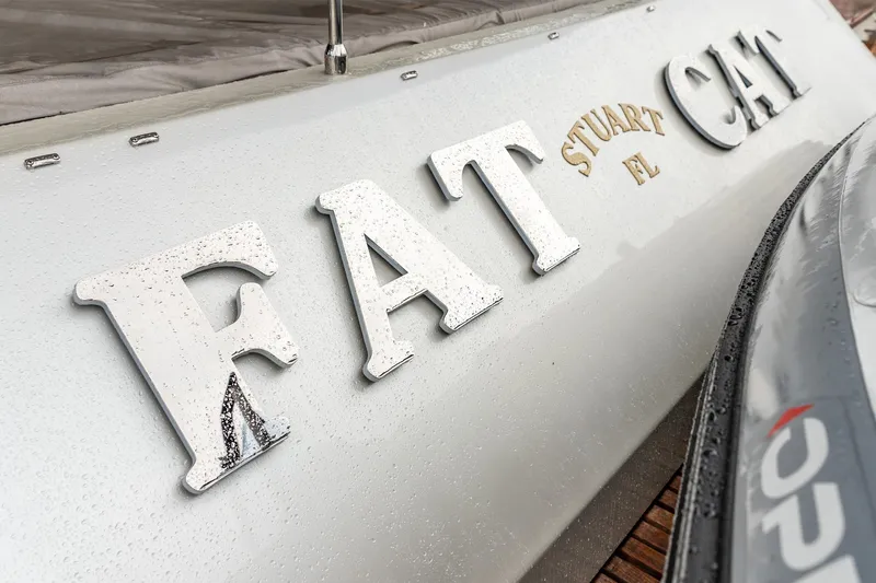 Fat Cat Yacht Photos Pics 2024 Sunreef 80 Power yacht with "FAT CAT" nameplate, featuring raindrops on the surface.
