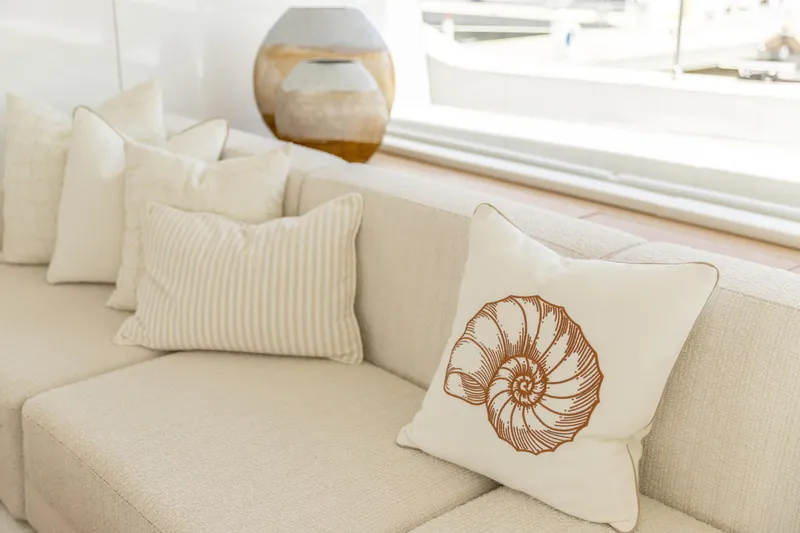 Fat Cat Yacht Photos Pics Luxurious Sunreef 80 Power 2024 yacht interior with elegant beige cushions and seashell design.