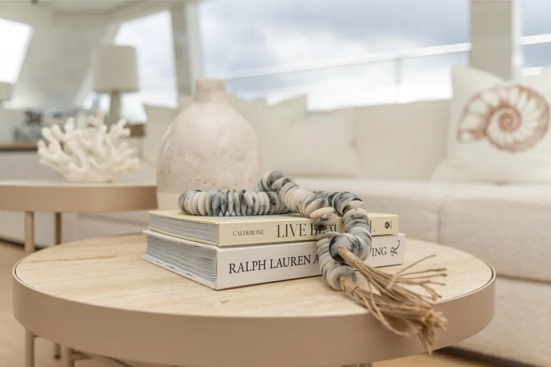 Fat Cat Yacht Photos Pics Luxurious Sunreef 80 Power yacht interior with elegant decor and books, 2024 model.