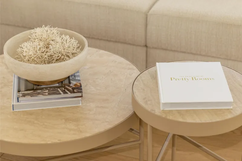 Fat Cat Yacht Photos Pics Modern interior with decorative coral bowl and book on round tables, Sunreef 80 Power 2024 yacht.