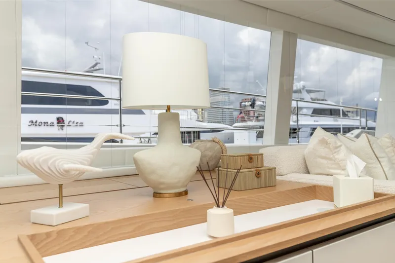 Fat Cat Yacht Photos Pics Luxurious interior of 2024 Sunreef 80 Power yacht with elegant decor and marina view.