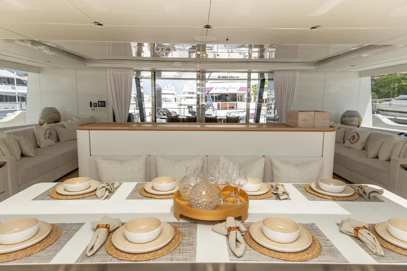 Fat Cat Yacht Photos Pics Luxurious interior of 2024 Sunreef 80 Power yacht with elegant dining setup.