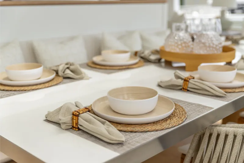 Fat Cat Yacht Photos Pics Elegant dining setup on 2024 Sunreef 80 Power yacht, featuring neutral tones and stylish tableware.