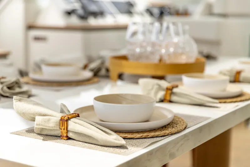 Fat Cat Yacht Photos Pics Elegant dining setup on Sunreef 80 Power yacht, 2024 model, featuring stylish tableware.