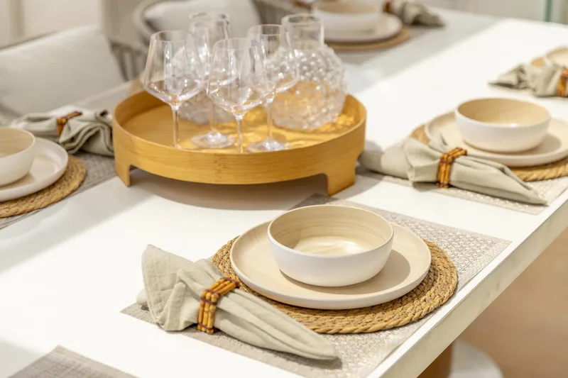 Fat Cat Yacht Photos Pics Elegant dining setup on Sunreef 80 Power yacht, featuring stylish tableware and glassware, 2024 model.