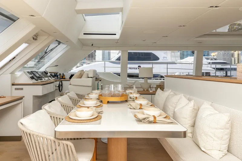 Fat Cat Yacht Photos Pics Luxurious interior of 2024 Sunreef 80 Power yacht with elegant dining setup.