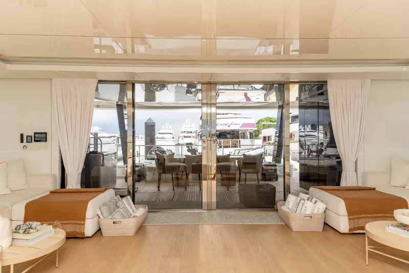 Fat Cat Yacht Photos Pics Luxurious interior of 2024 Sunreef 80 Power yacht with elegant decor and marina view.