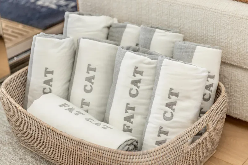 Fat Cat Yacht Photos Pics Basket of rolled towels labeled "Fat Cat" on Sunreef 80 Power yacht.