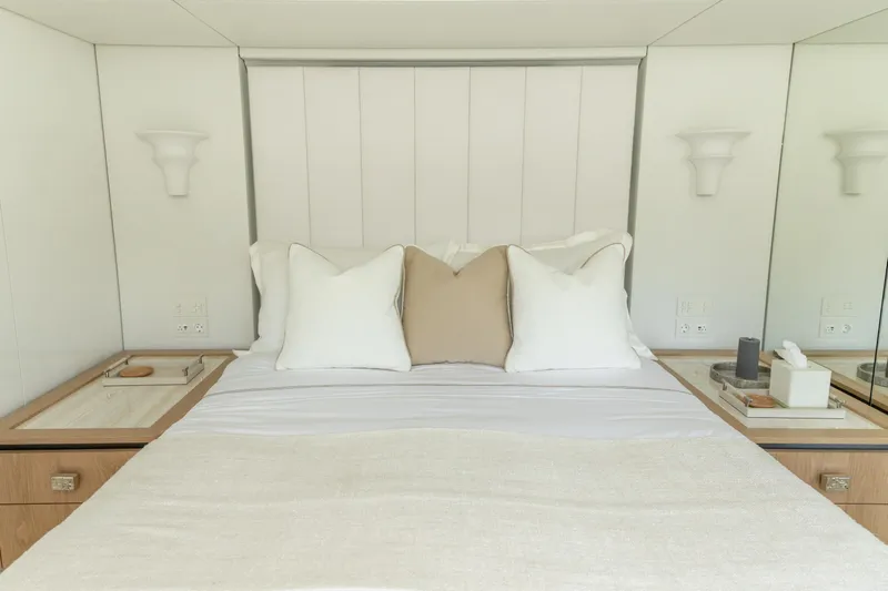 Fat Cat Yacht Photos Pics Luxurious bedroom interior on 2024 Sunreef 80 Power yacht, featuring elegant bedding and modern design.
