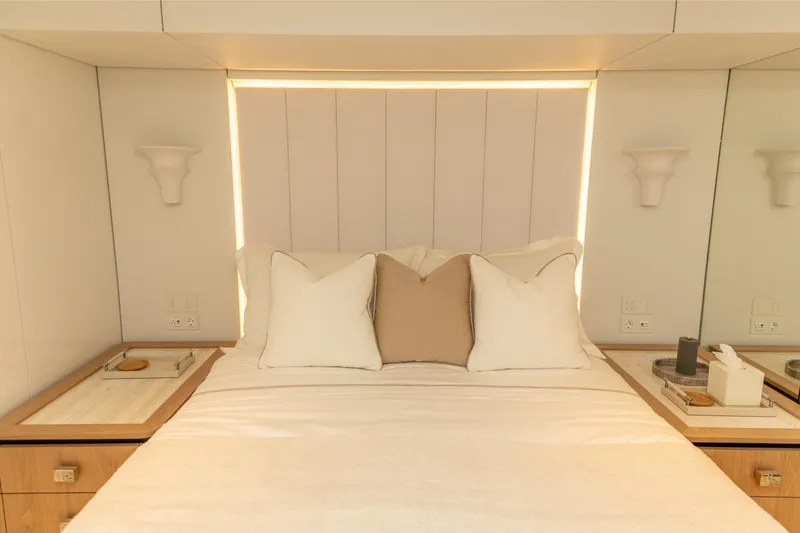 Fat Cat Yacht Photos Pics Luxurious bedroom interior of 2024 Sunreef 80 Power yacht with elegant bedding and soft lighting.