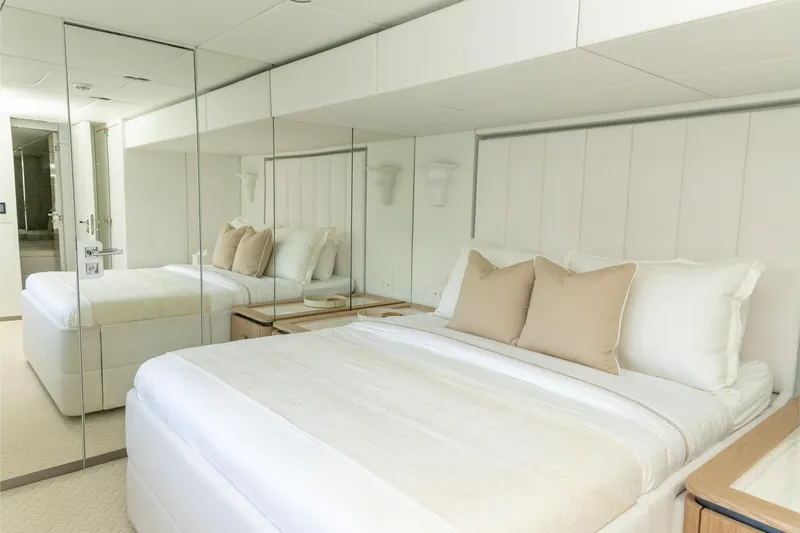 Fat Cat Yacht Photos Pics Luxurious bedroom interior on 2024 Sunreef 80 Power yacht, featuring elegant white decor.