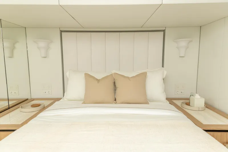 Fat Cat Yacht Photos Pics Luxurious bedroom interior of 2024 Sunreef 80 Power yacht with elegant bedding and modern design.