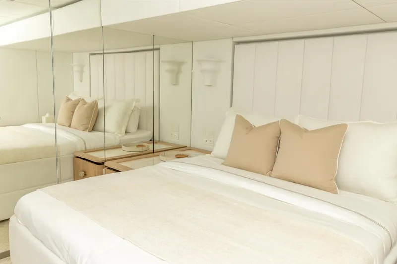 Fat Cat Yacht Photos Pics Luxurious bedroom interior on 2024 Sunreef 80 Power yacht, featuring elegant bedding and mirrored walls.