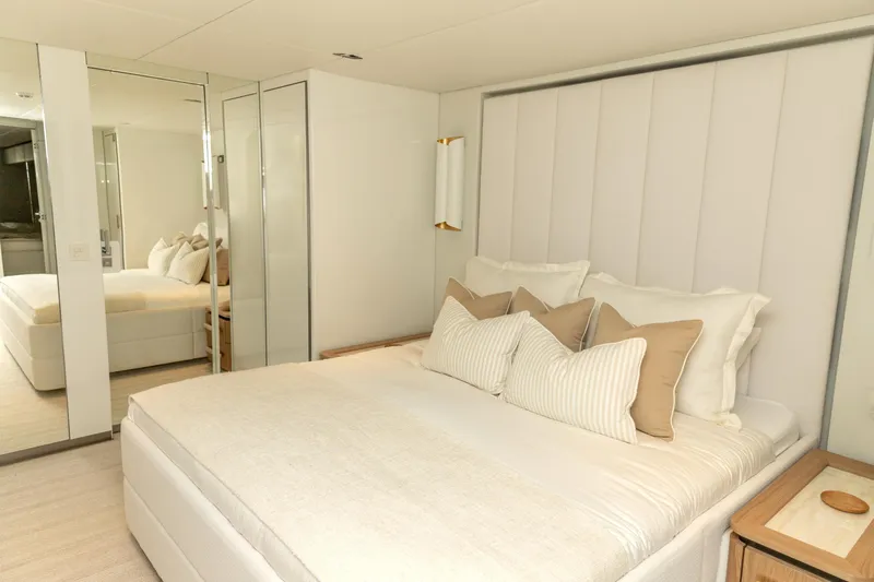 Fat Cat Yacht Photos Pics Luxurious bedroom interior on 2024 Sunreef 80 Power yacht, featuring elegant bedding and modern design.