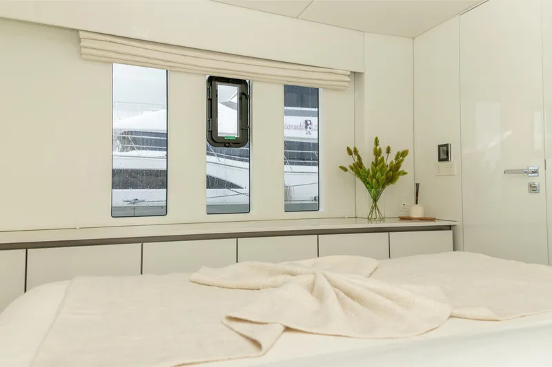 Fat Cat Yacht Photos Pics Luxurious interior of 2024 Sunreef 80 Power yacht with elegant decor and large windows.