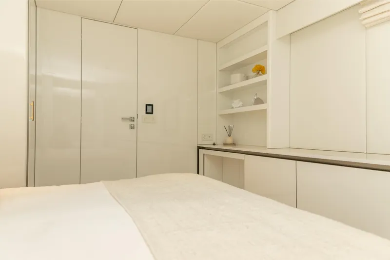 Fat Cat Yacht Photos Pics Luxurious interior of 2024 Sunreef 80 Power yacht, featuring sleek white cabinetry and modern design.