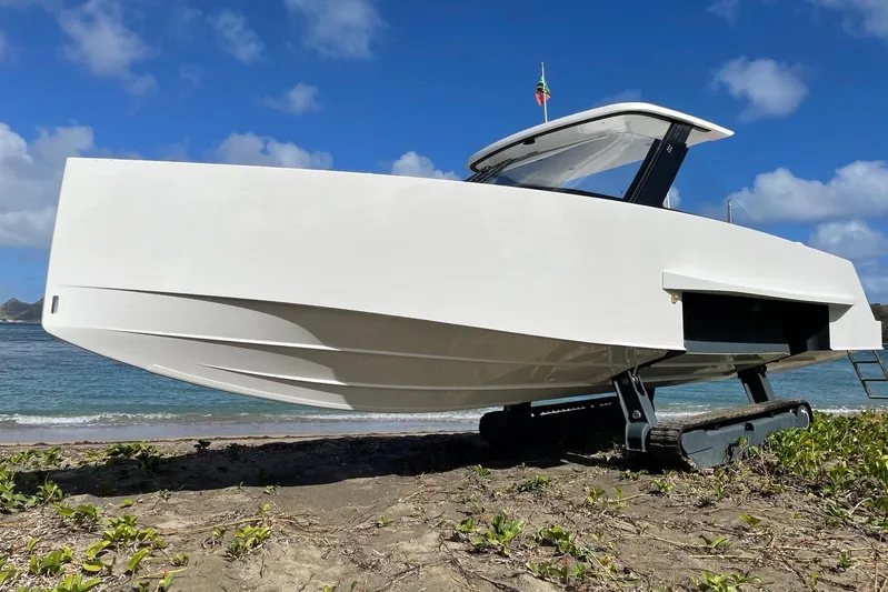  Yacht Photos Pics 2019 IGUANA Yachts Commuter on beach with retractable tracks, under clear blue sky.