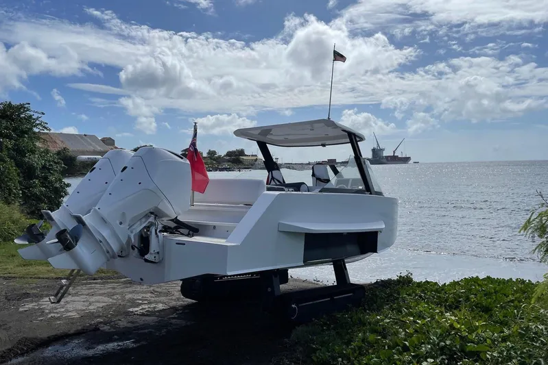  Yacht Photos Pics 2019 IGUANA Yachts Commuter on land, near ocean, with clear sky and distant ships.