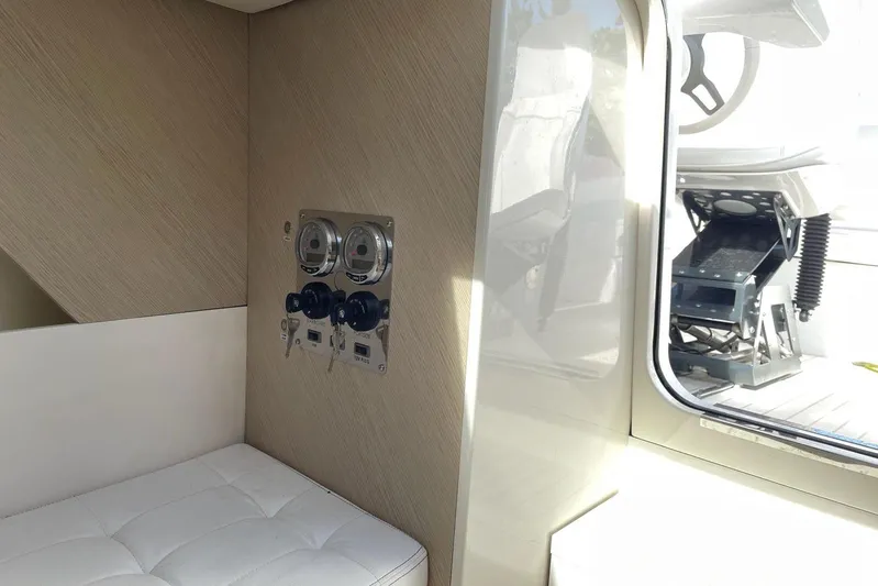  Yacht Photos Pics Interior of 2019 IGUANA Yachts Commuter, featuring control panel and seating area.