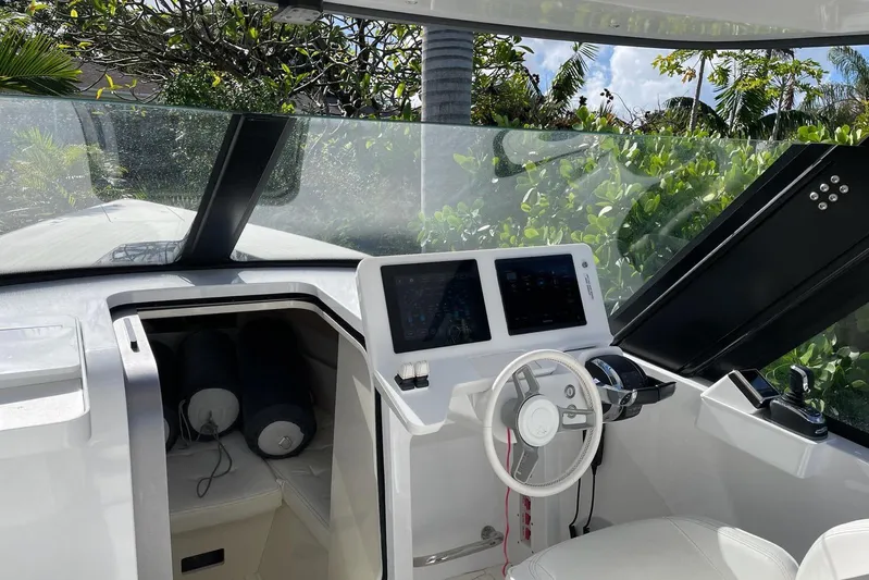  Yacht Photos Pics 2019 IGUANA Yachts Commuter cockpit with steering wheel and navigation screens.