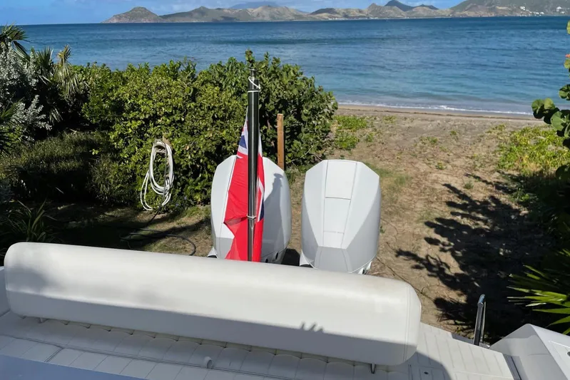  Yacht Photos Pics 2019 IGUANA Yachts Commuter on beach with scenic ocean and mountain backdrop.