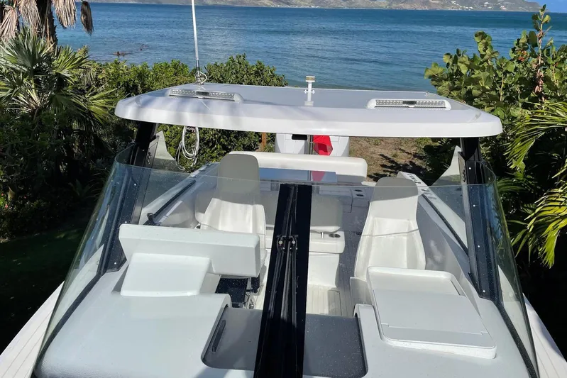  Yacht Photos Pics 2019 IGUANA Yachts Commuter on scenic waterfront with lush greenery and ocean view.