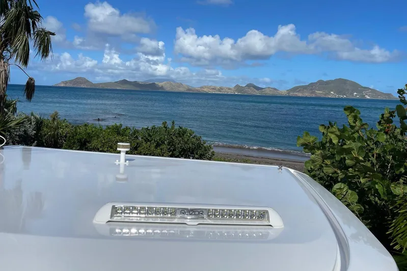  Yacht Photos Pics 2019 IGUANA Yachts Commuter with ocean view and distant islands under blue sky.