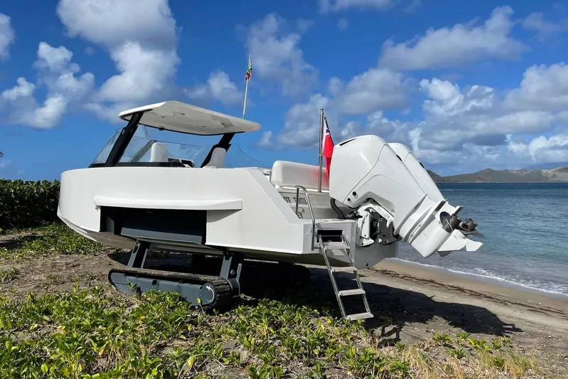  Yacht Photos Pics 2019 IGUANA Yachts Commuter on beach with tracks, ocean backdrop, and blue sky.