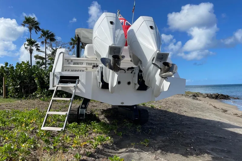  Yacht Photos Pics 2019 IGUANA Yachts Commuter on beach, featuring dual outboard motors and retractable tracks.