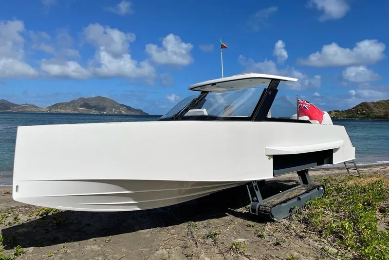  Yacht Photos Pics 2019 IGUANA Yachts Commuter on beach with tracks, ocean and mountains in background.