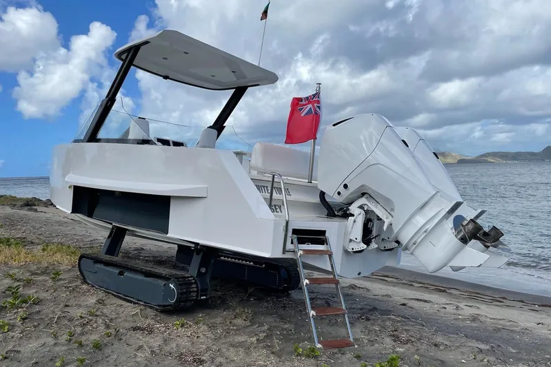  Yacht Photos Pics 2019 IGUANA Yachts Commuter with tracks on a beach, featuring a red flag.