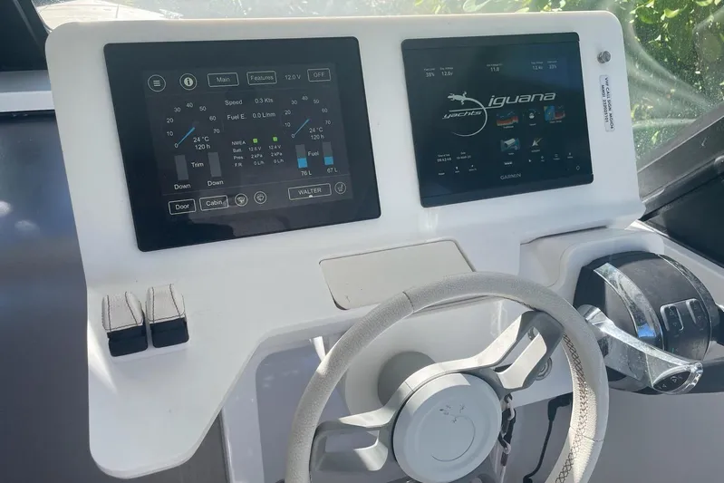  Yacht Photos Pics Control panel of 2019 IGUANA Yachts Commuter with digital displays and steering wheel.