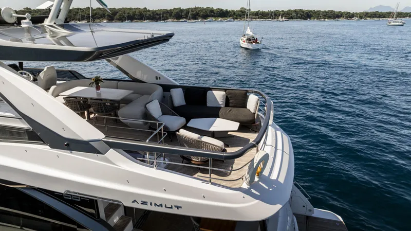  Yacht Photos Pics 2023 Azimut Fly 68 yacht with luxurious deck seating on open water.