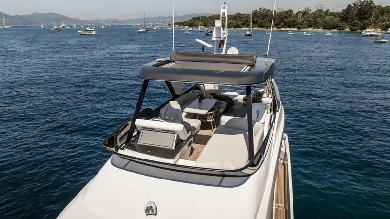  Yacht Photos Pics 2023 Azimut Fly 68 yacht on serene blue waters, surrounded by other boats.