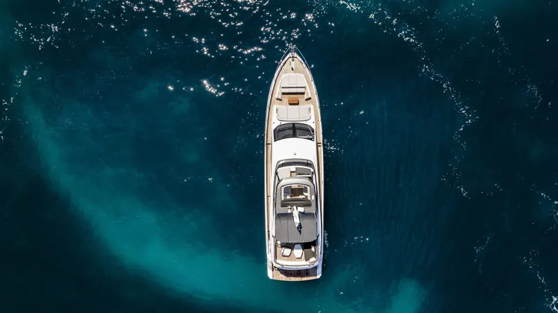  Yacht Photos Pics Aerial view of 2023 Azimut Fly 68 yacht cruising in clear blue waters.