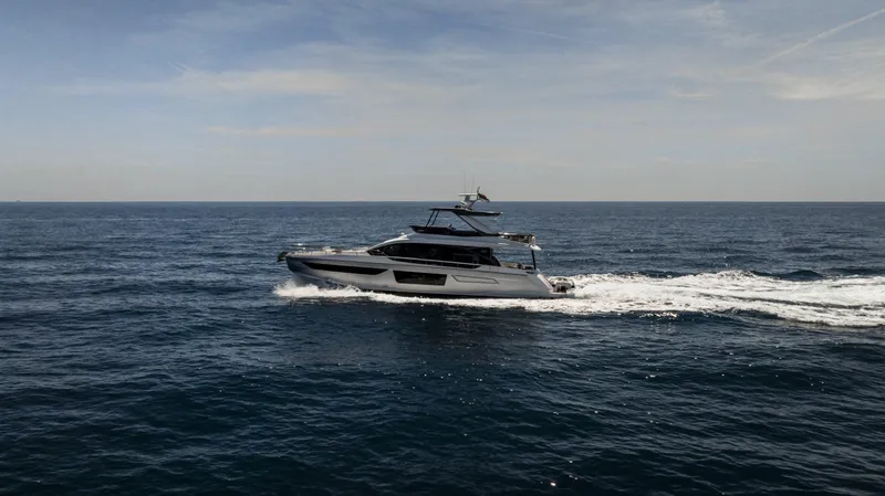  Yacht Photos Pics 2023 Azimut Fly 68 yacht cruising on open sea under clear sky.