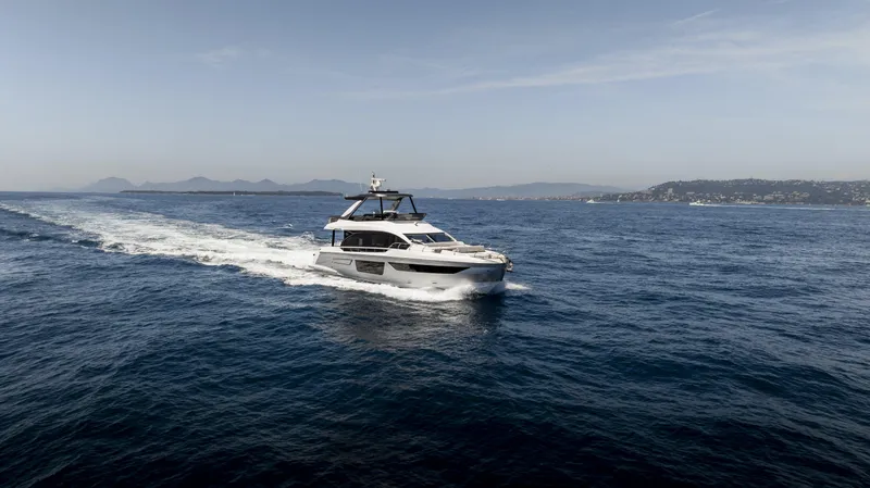 Yacht Photos Pics 2023 Azimut Fly 68 yacht cruising on open sea under clear sky.