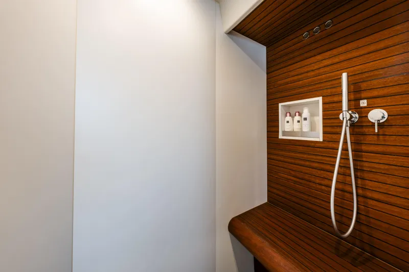  Yacht Photos Pics Luxurious shower area in 2023 Azimut Fly 68 yacht with wooden paneling.