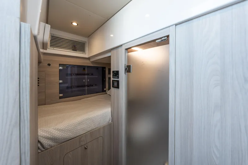  Yacht Photos Pics 2023 Azimut Fly 68 yacht interior cabin with modern design and cozy bedding.