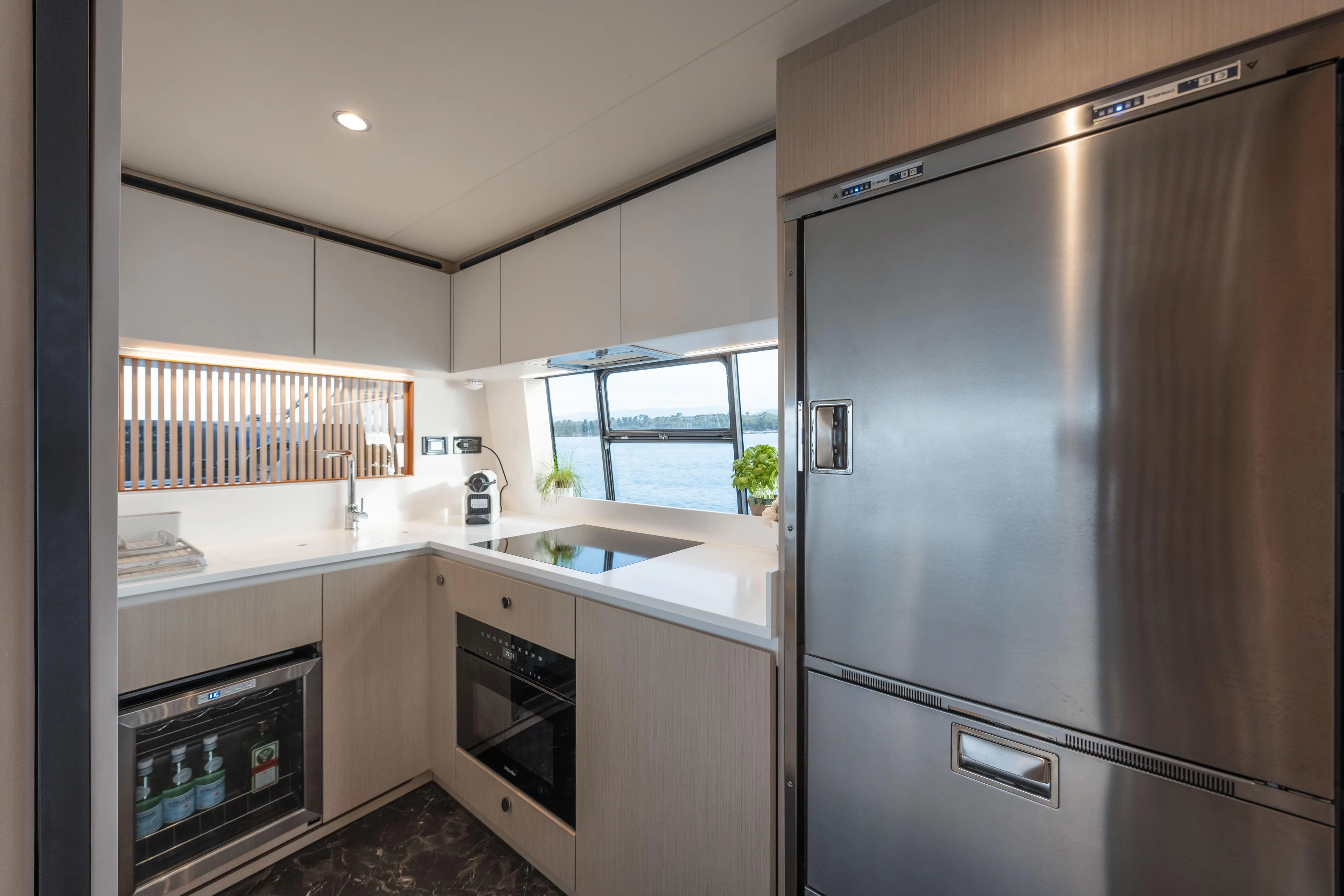  Yacht Photos Pics Modern kitchen interior on 2023 Azimut Fly 68 yacht, featuring sleek appliances and ocean view.
