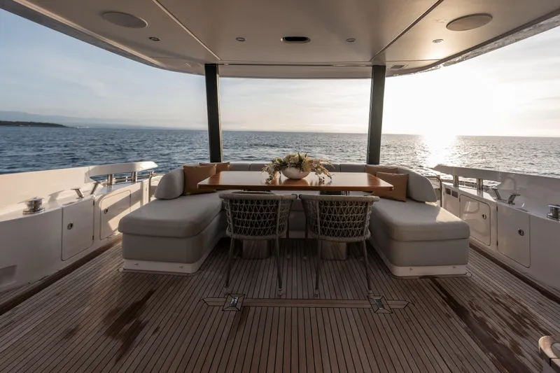  Yacht Photos Pics Luxurious 2023 Azimut Fly 68 yacht deck with elegant seating, ocean view, and sunset ambiance.