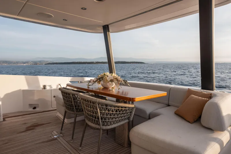  Yacht Photos Pics Luxurious 2023 Azimut Fly 68 yacht deck with elegant seating and ocean view.