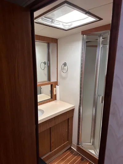Kemo Sabe Yacht Photos Pics 1981 Bertram 45 Convertible yacht bathroom with wood accents and shower.