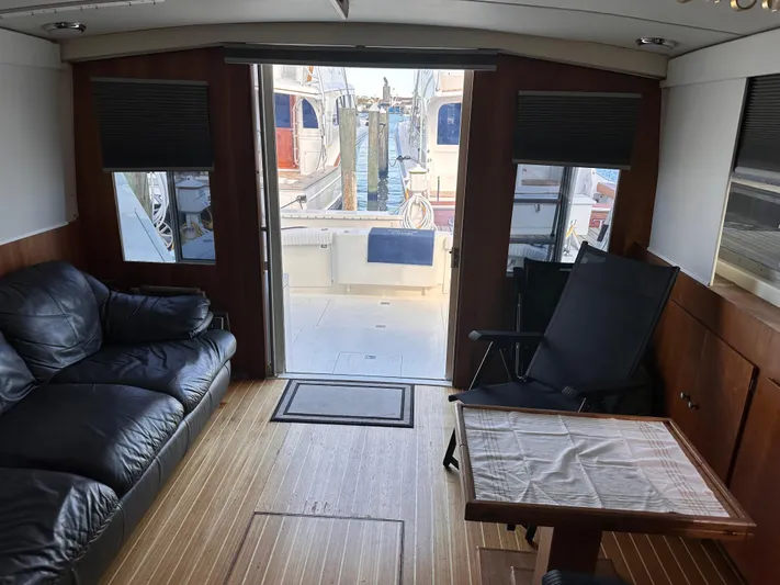 Kemo Sabe Yacht Photos Pics Interior of 1981 Bertram 45 Convertible yacht with leather seating and wooden flooring.