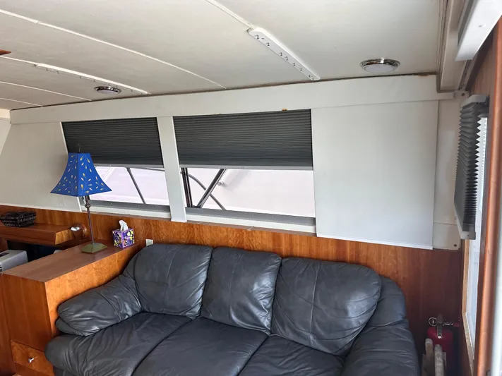Kemo Sabe Yacht Photos Pics Interior of 1981 Bertram 45 Convertible with leather sofa and blue lamp.